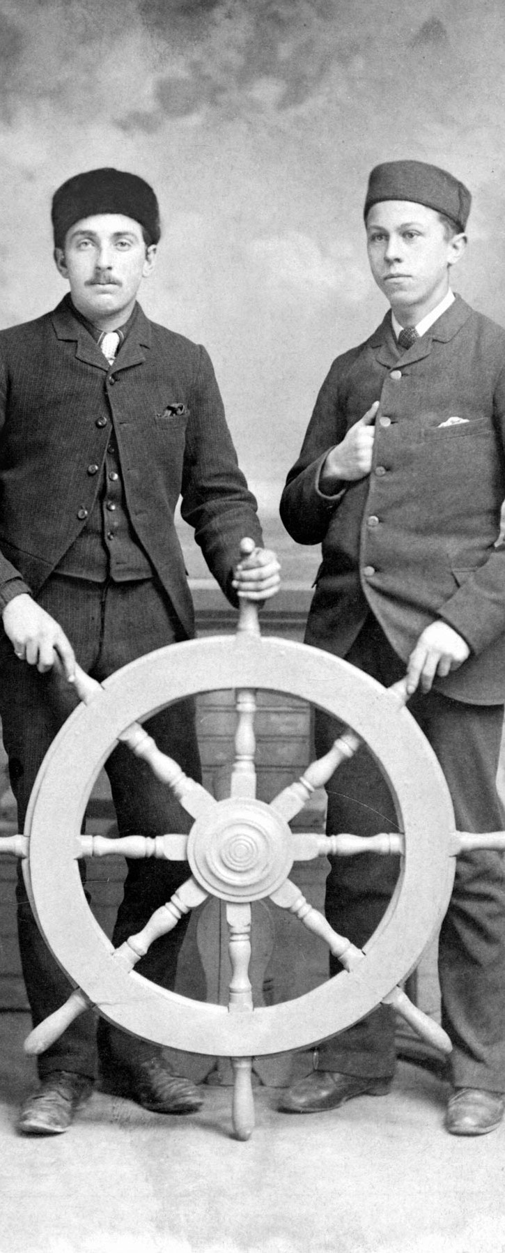 Vintage sailors at a ship wheel